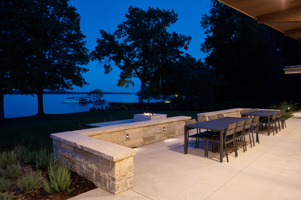 Inspiration for an expansive modern backyard patio in Grand Rapids with a fire feature.
