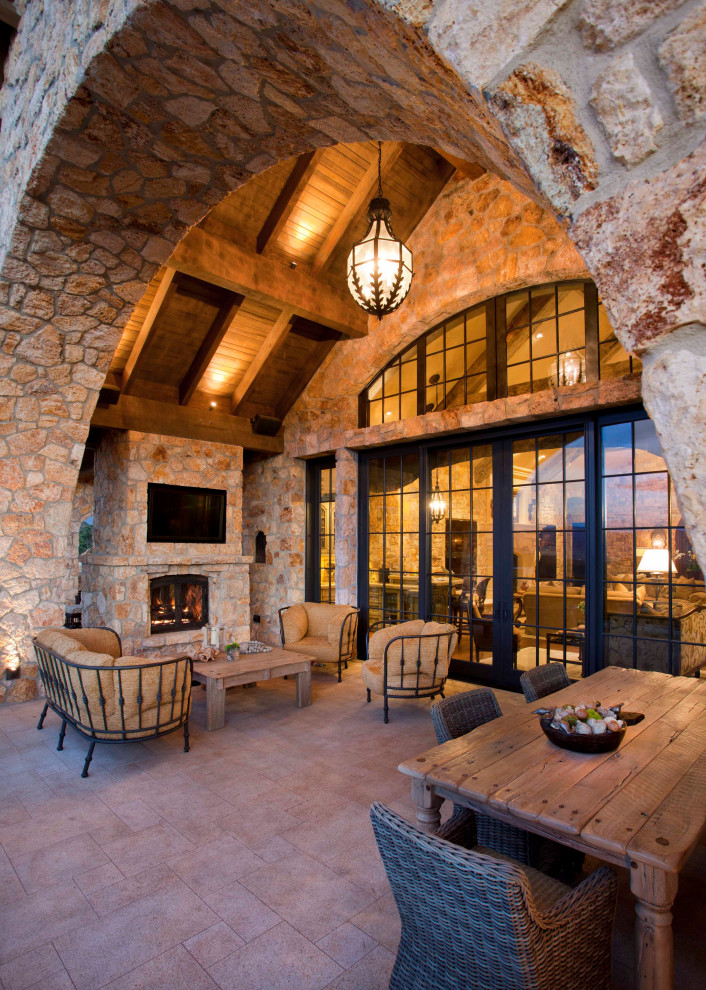 Inspiration for a country patio in Salt Lake City with with fireplace, a roof extension and tile.
