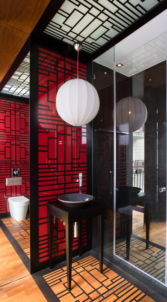 Photo of an asian bathroom in Other with a vessel sink and red walls.