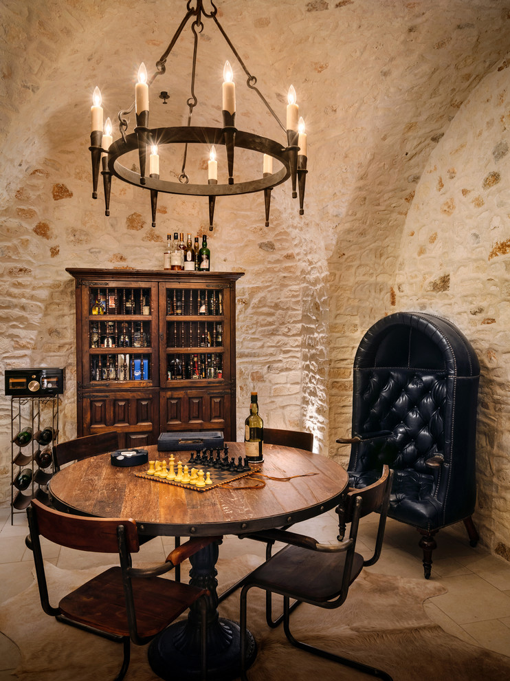 Mediterranean wine cellar in Austin with beige floor.