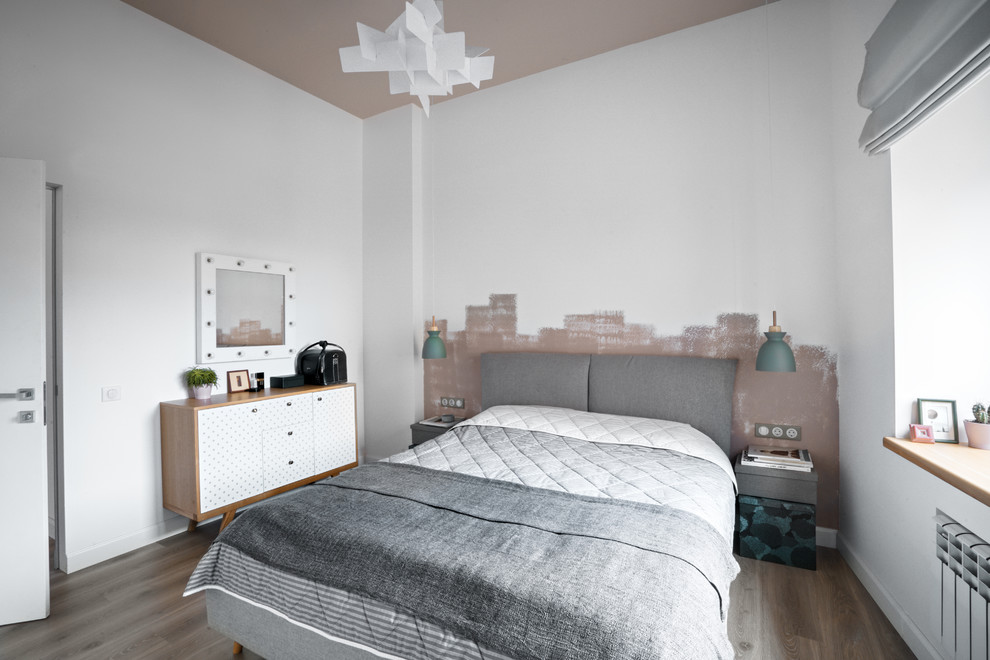 Photo of a scandinavian master bedroom in Saint Petersburg with white walls, medium hardwood floors and grey floor.