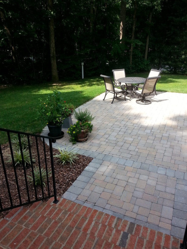 Design ideas for a mid-sized eclectic backyard patio in Raleigh with concrete pavers.