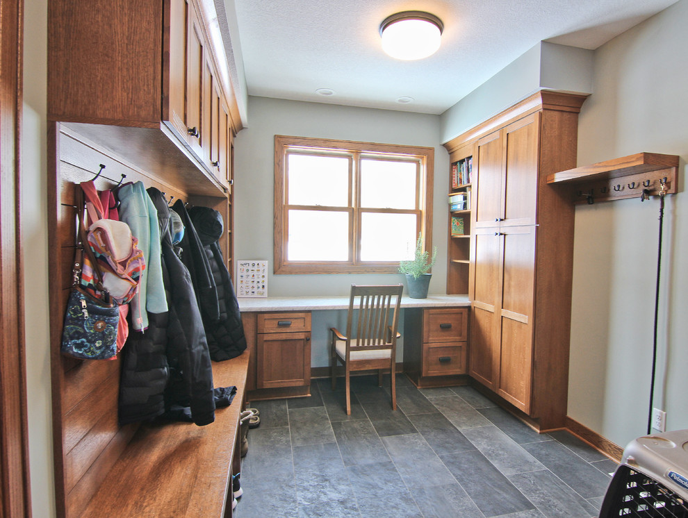 Design ideas for a mid-sized transitional mudroom in Minneapolis with grey walls, vinyl floors and grey floor.
