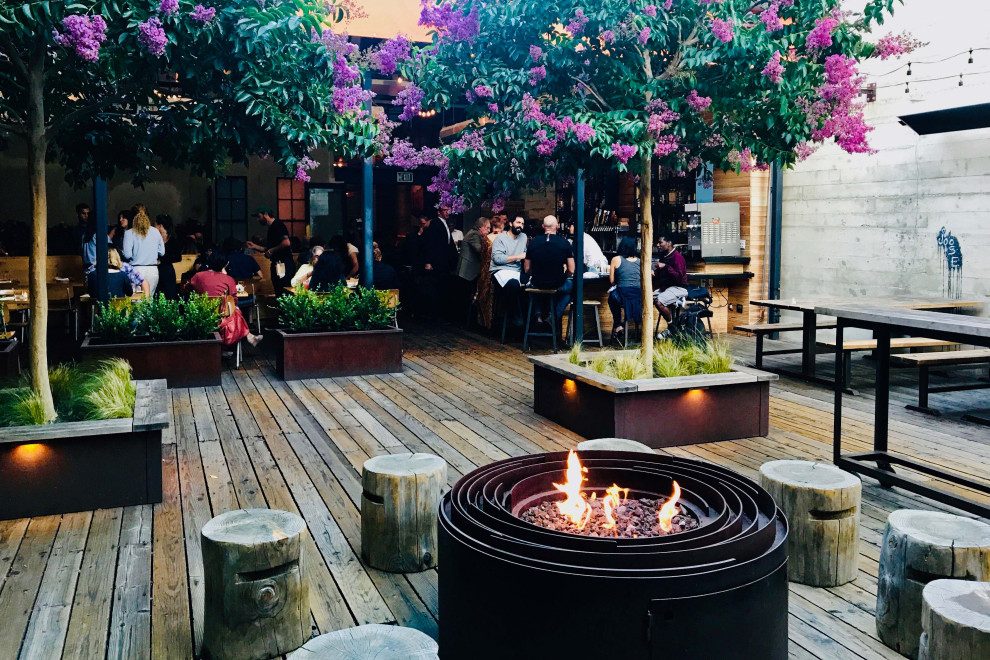 Country courtyard deck in San Francisco with a fire feature and no cover.