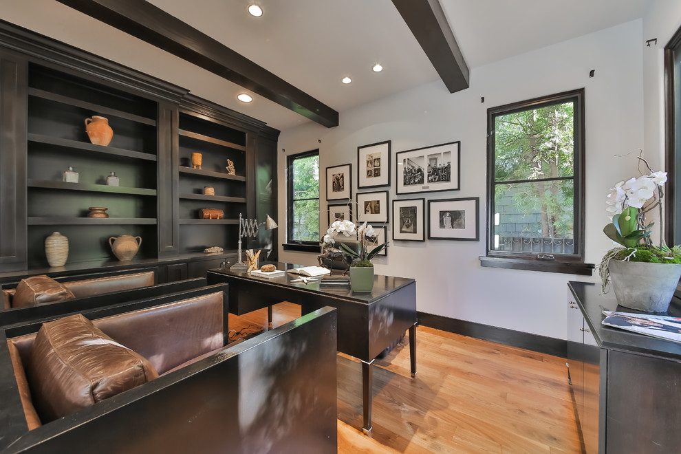 Photo of a contemporary home office in Los Angeles with white walls, medium hardwood floors and a freestanding desk.
