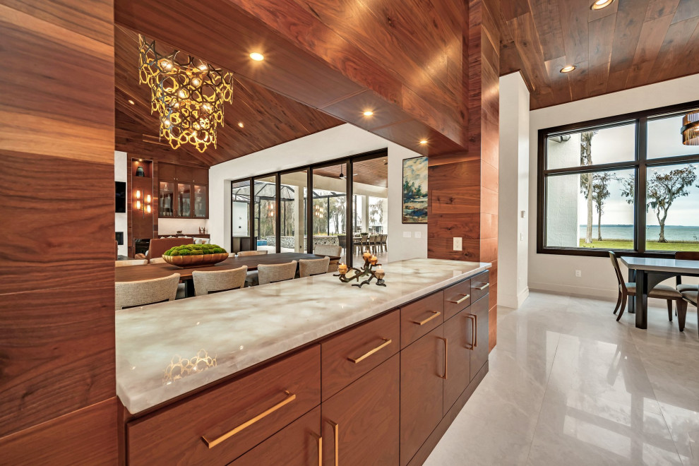 Eat-in kitchen - large transitional u-shaped wood ceiling eat-in kitchen idea in Orlando with a farmhouse sink, shaker cabinets, white cabinets, stainless steel appliances and an island