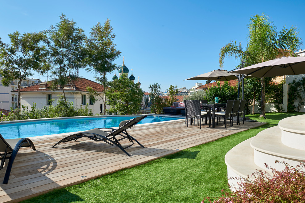 Photo of a mediterranean backyard rectangular lap pool in Nice with decking.