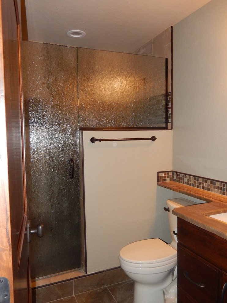 Small mediterranean 3/4 bathroom in Denver with an open shower, a one-piece toilet, ceramic floors, an undermount sink, laminate benchtops, a hinged shower door, a single vanity and a built-in vanity.