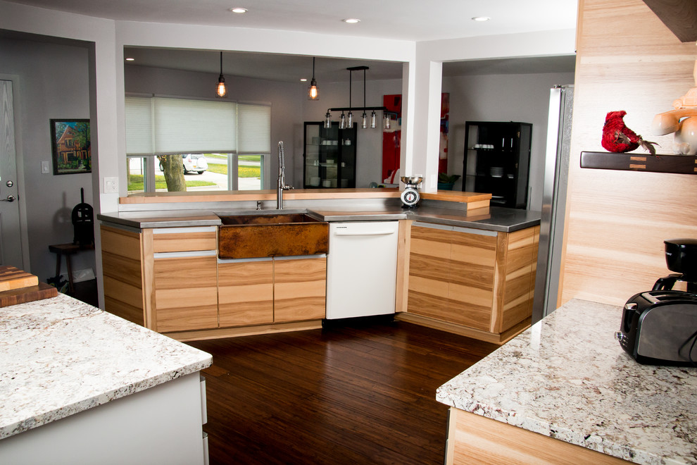Photo of a mid-sized contemporary u-shaped eat-in kitchen in Milwaukee with a farmhouse sink, flat-panel cabinets, medium wood cabinets, stainless steel benchtops, metallic splashback, white appliances, dark hardwood floors, with island, brown floor and metal splashback.