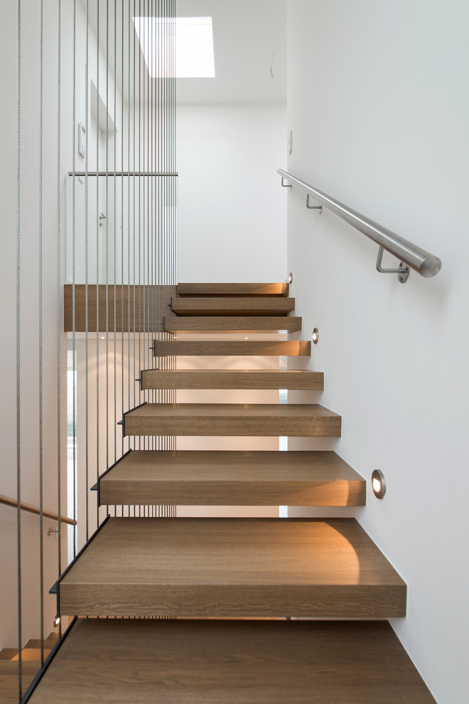 Inspiration for a contemporary wood floating staircase in Frankfurt.