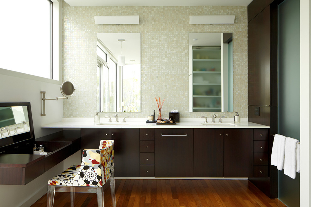 Photo of a large modern master bathroom in New York with mosaic tile, dark wood cabinets, flat-panel cabinets, white tile, white walls, medium hardwood floors and an undermount sink.