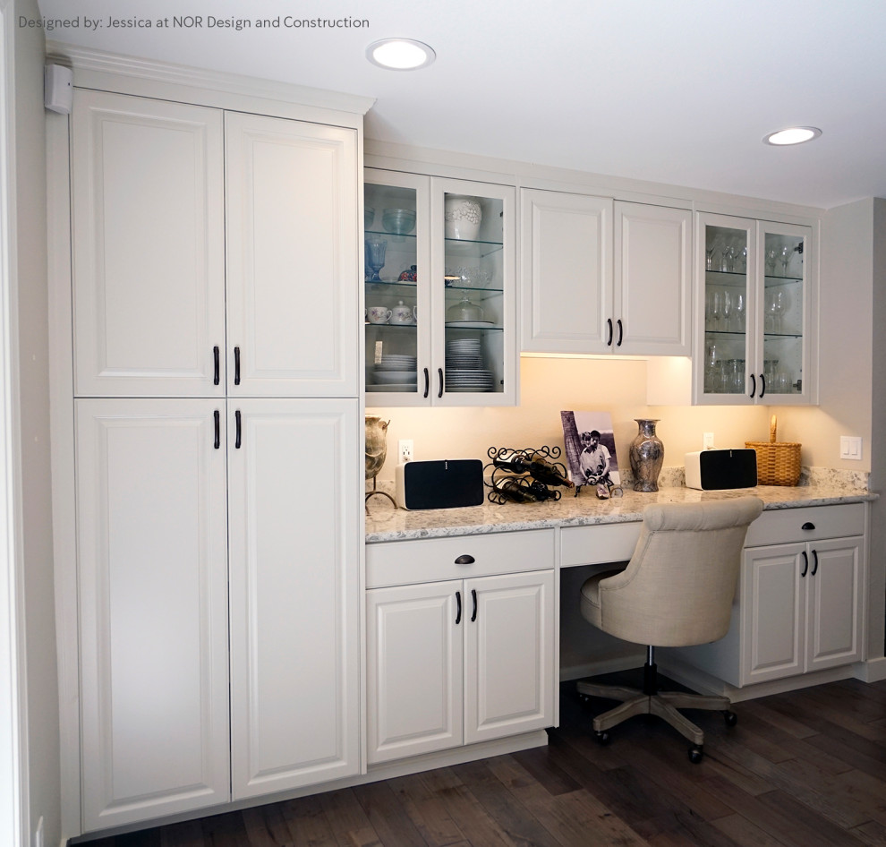 Inspiration for a large transitional u-shaped medium tone wood floor eat-in kitchen remodel in Seattle with recessed-panel cabinets, white cabinets, an island, white countertops, quartzite countertops and stainless steel appliances