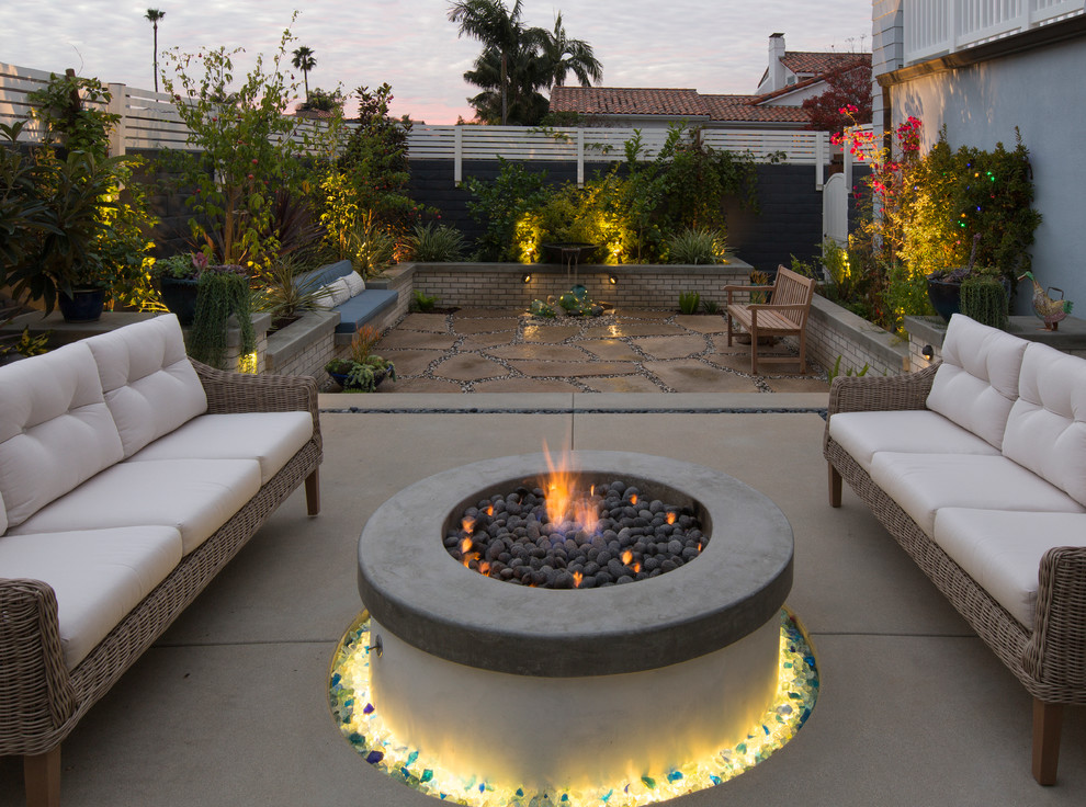 This is an example of a transitional patio in Los Angeles with a fire feature and no cover.