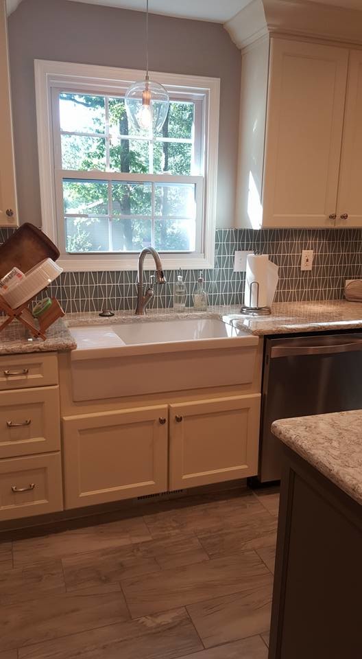 Large transitional u-shaped eat-in kitchen photo in Baltimore with shaker cabinets, white cabinets, granite countertops, stainless steel appliances and an island