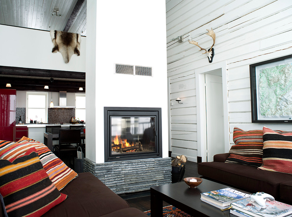 This is an example of a mid-sized country living room in Other with white walls, dark hardwood floors, a standard fireplace and a metal fireplace surround.