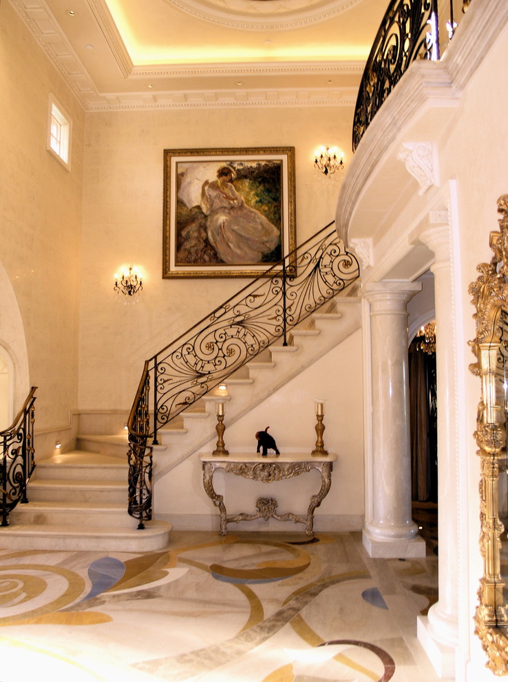Large traditional foyer in Los Angeles with beige walls and marble floors.