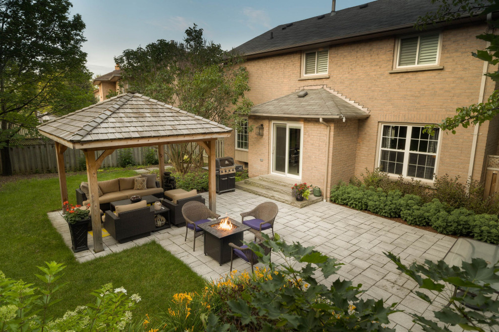 This is an example of a mid-sized contemporary backyard garden in Toronto with concrete pavers.