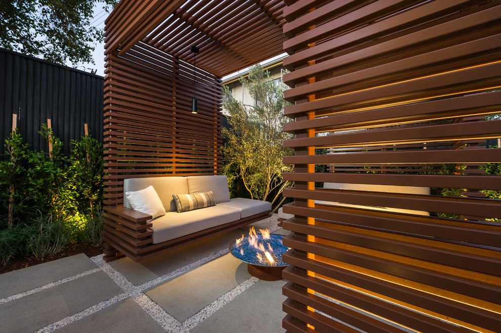 Small contemporary backyard deck in Los Angeles with a fire feature and a pergola.