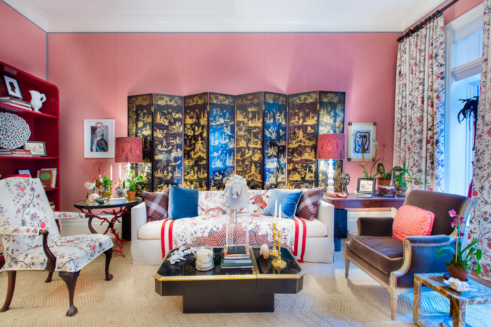 Eclectic enclosed living room in New York with pink walls.