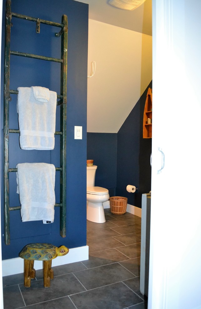 Mid-sized beach style bathroom in Baltimore with an alcove tub, an alcove shower, a two-piece toilet, porcelain tile, blue walls, porcelain floors, a pedestal sink, beige tile, grey floor and a shower curtain.
