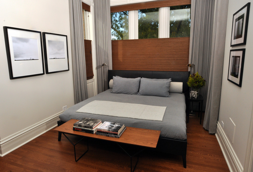 Design ideas for a large contemporary master bedroom in Chicago with white walls and medium hardwood floors.