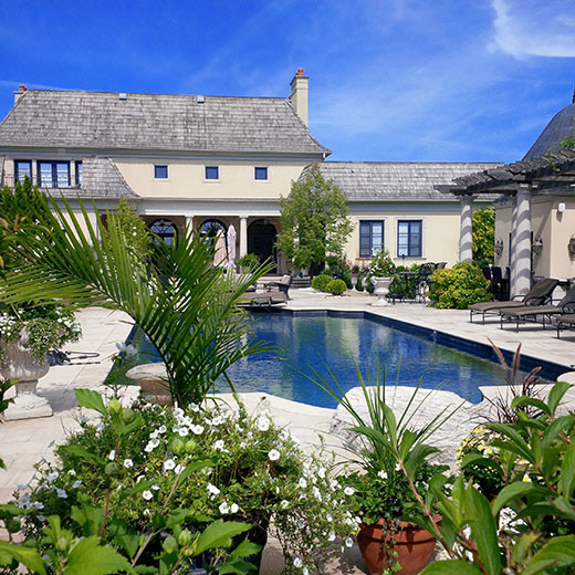 Large transitional backyard stone and custom-shaped pool fountain photo in Toronto