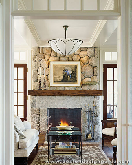 Photo of an expansive traditional open concept living room in Boston with a library, white walls, dark hardwood floors, a standard fireplace and a stone fireplace surround.