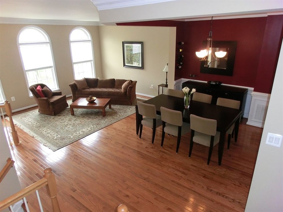Mid-sized transitional medium tone wood floor dining room photo with multicolored walls and no fireplace