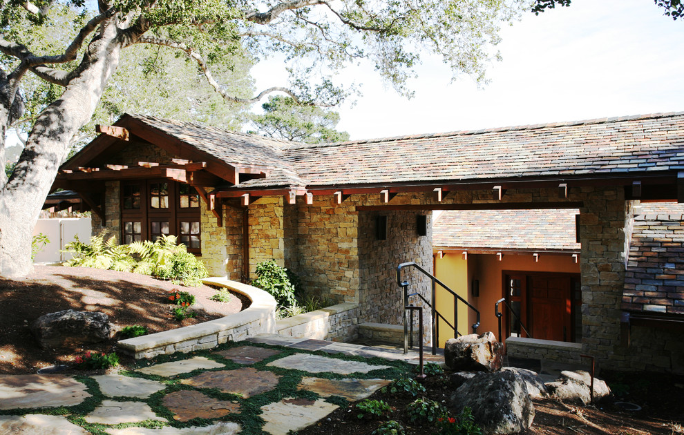 This is an example of a mid-sized arts and crafts two-storey brown exterior in San Francisco with stone veneer and a hip roof.