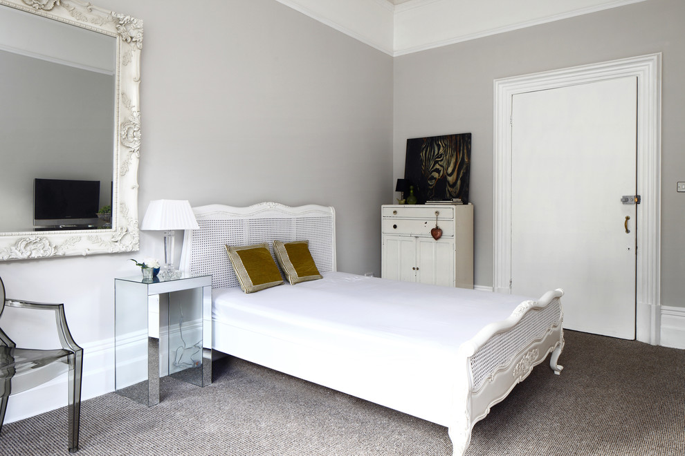 Inspiration for a mid-sized scandinavian master bedroom in Sussex with grey walls and carpet.