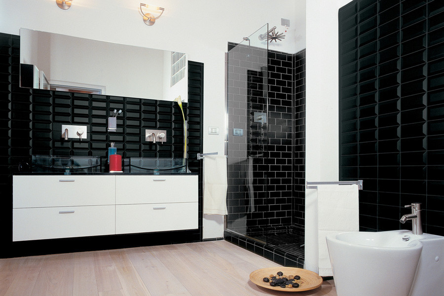 This is an example of a mid-sized modern master bathroom in Sydney with glass-front cabinets, white cabinets, a drop-in tub, an open shower, a one-piece toilet, beige tile, porcelain tile, black walls, porcelain floors, an integrated sink and quartzite benchtops.