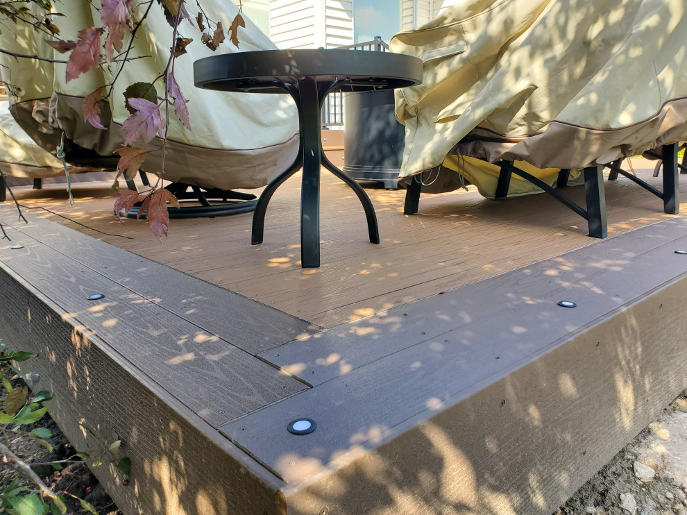 Deck - large backyard ground level metal railing deck idea with a roof extension