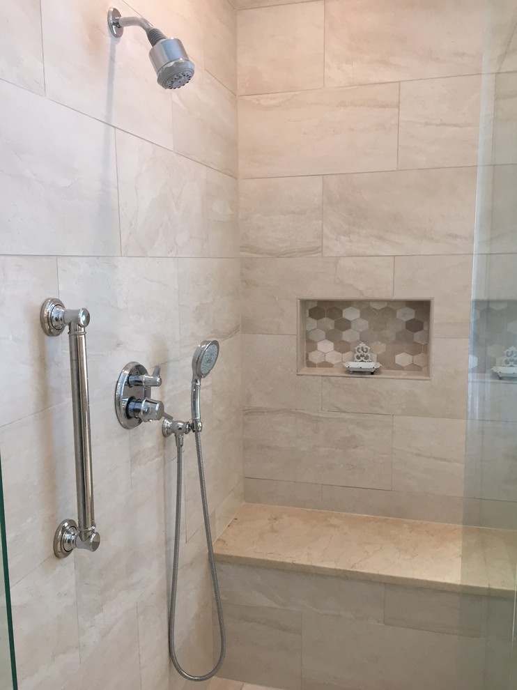This is an example of a large transitional master bathroom in Nashville with raised-panel cabinets, white cabinets, a freestanding tub, a corner shower, a two-piece toilet, beige tile, multi-coloured tile, mosaic tile, blue walls, porcelain floors, an undermount sink and marble benchtops.