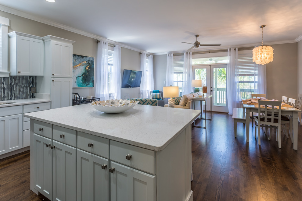 Example of a mid-sized transitional formal and open concept dark wood floor and brown floor kitchen design in Miami with beige walls and a wall-mounted tv