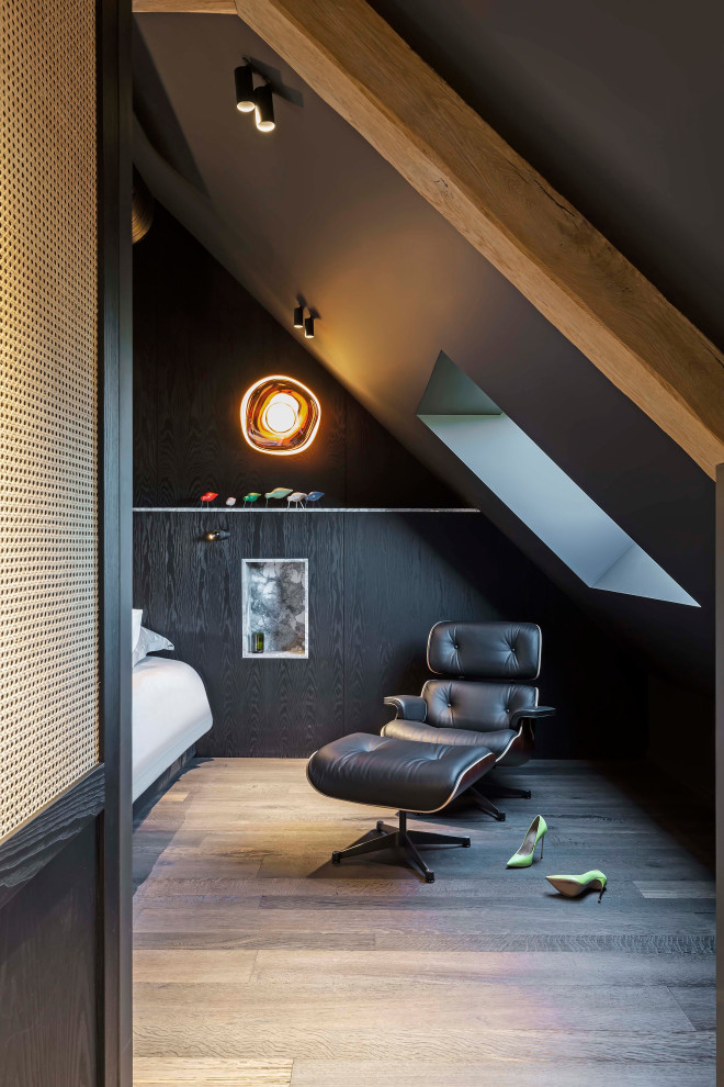 Design ideas for a large industrial master bedroom in Paris with black walls, dark hardwood floors and black floor.