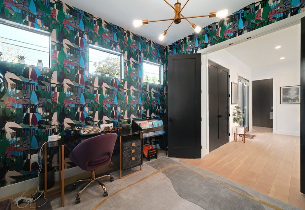 Design ideas for a contemporary home office in Austin with wallpapered walls.