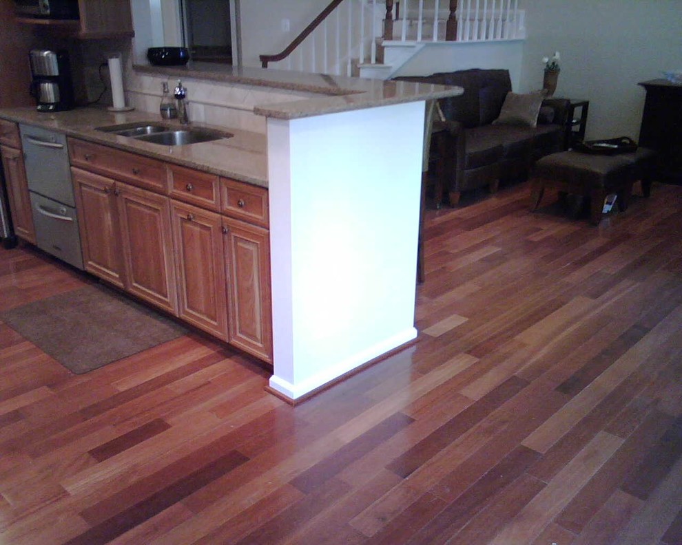 Example of a medium tone wood floor kitchen design in DC Metro with medium tone wood cabinets and stainless steel appliances