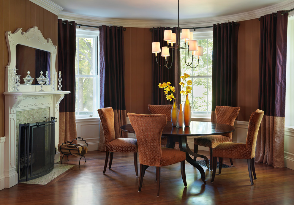 Inspiration for a traditional dining room in Boston with dark hardwood floors and a standard fireplace.