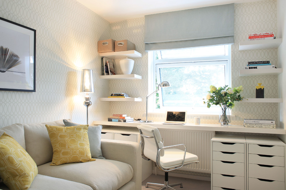 Photo of a mid-sized transitional study room in London with multi-coloured walls and a built-in desk.
