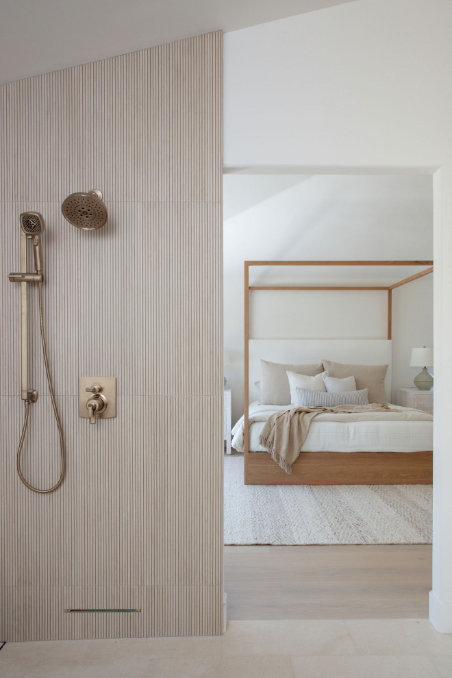 Inspiration for a large coastal master beige tile and porcelain tile limestone floor, beige floor and double-sink bathroom remodel in San Diego with light wood cabinets, a wall-mount toilet, white walls and a hinged shower door