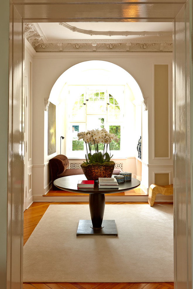 This is an example of a large traditional foyer in Dresden with beige walls and medium hardwood floors.