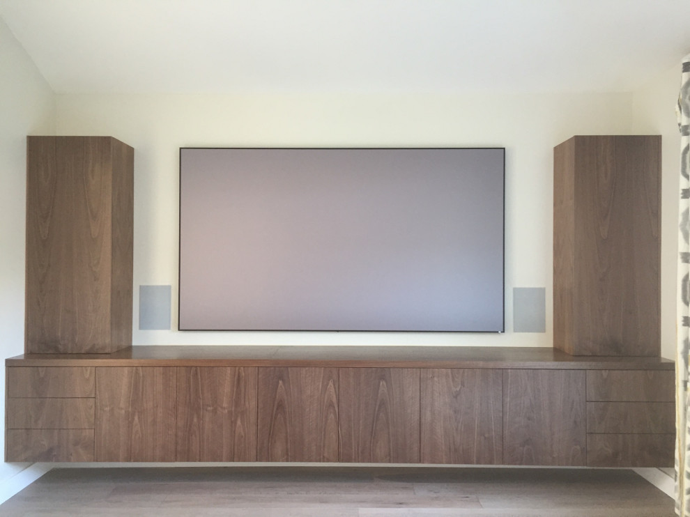 Mid-sized minimalist enclosed light wood floor and beige floor home theater photo in Los Angeles with beige walls and a media wall