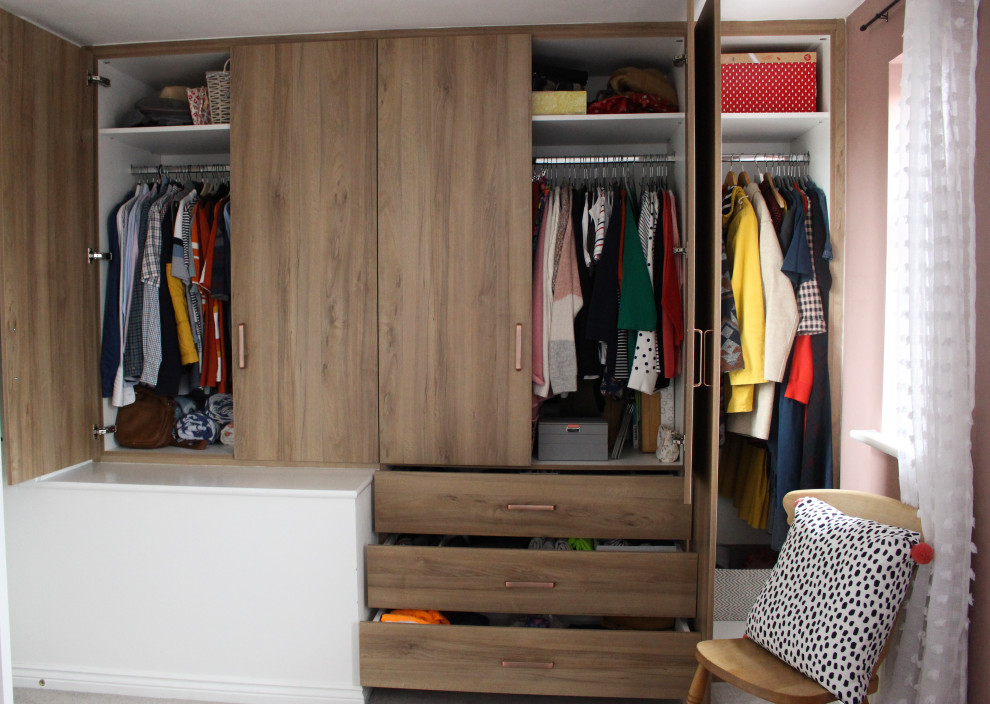 Design ideas for a medium sized vintage wardrobe in Hertfordshire with carpet, grey floors and a vaulted ceiling.