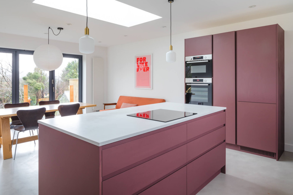 Inspiration for a mid-sized contemporary l-shaped eat-in kitchen in Other with a drop-in sink, flat-panel cabinets, purple cabinets, quartzite benchtops, white splashback, concrete floors, with island, grey floor and white benchtop.