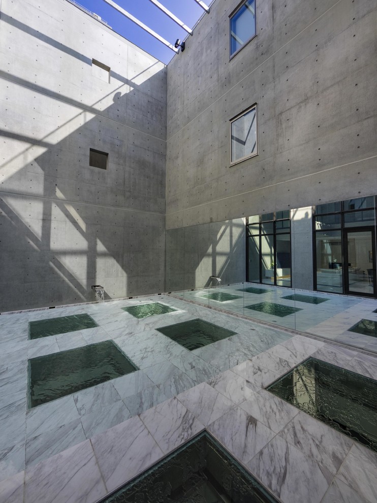 This is an example of an industrial courtyard patio in Tokyo with no cover.