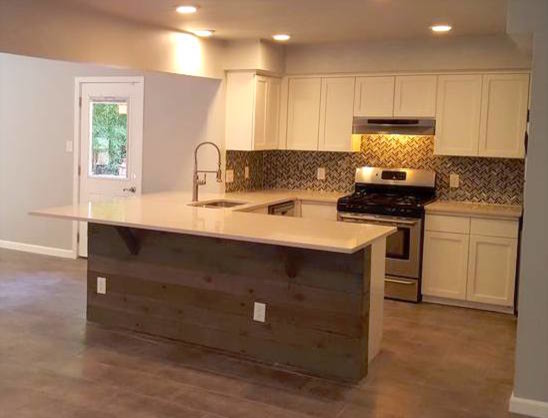 Open concept kitchen - mid-sized transitional l-shaped porcelain tile open concept kitchen idea in Austin with an undermount sink, shaker cabinets, white cabinets, limestone countertops, multicolored backsplash, glass tile backsplash, stainless steel appliances and a peninsula