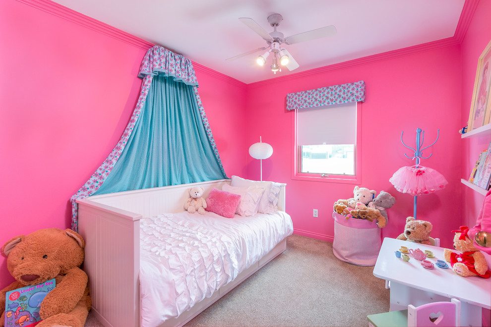 Photo of a small scandinavian kids' room for girls in Calgary with pink walls and carpet.