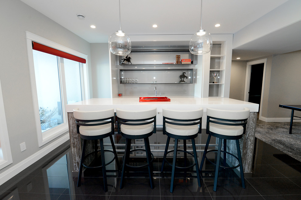 Mid-sized contemporary single-wall seated home bar in Edmonton with flat-panel cabinets, an undermount sink, white cabinets, quartzite benchtops, grey splashback, glass sheet splashback and porcelain floors.