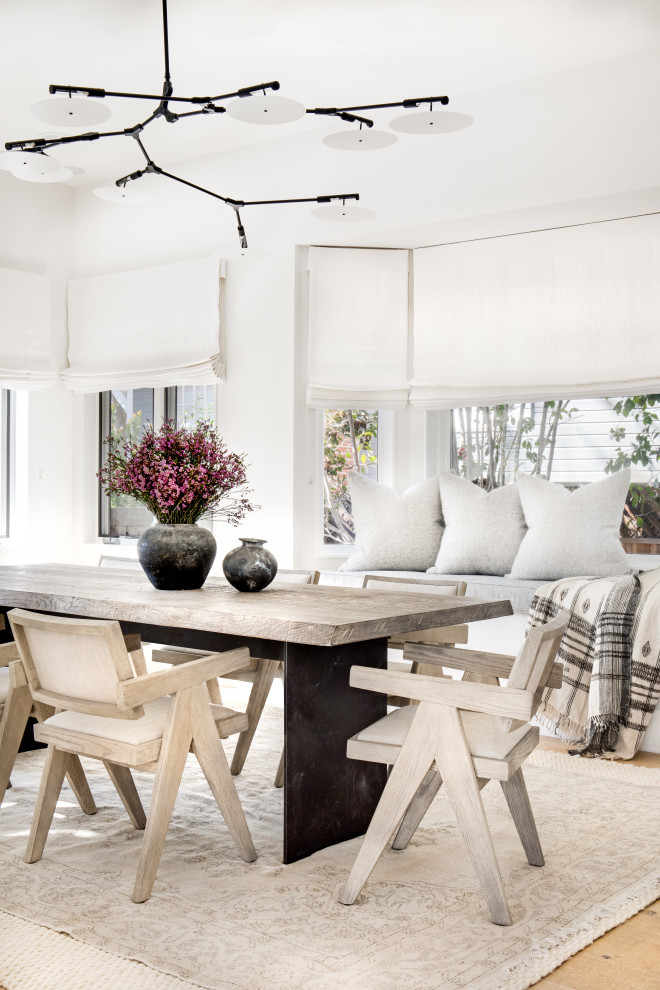 Inspiration for a mid-sized scandinavian dining room in San Diego with white walls, light hardwood floors and beige floor.