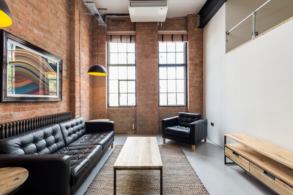 This is an example of an industrial living room in London with white walls and no fireplace.